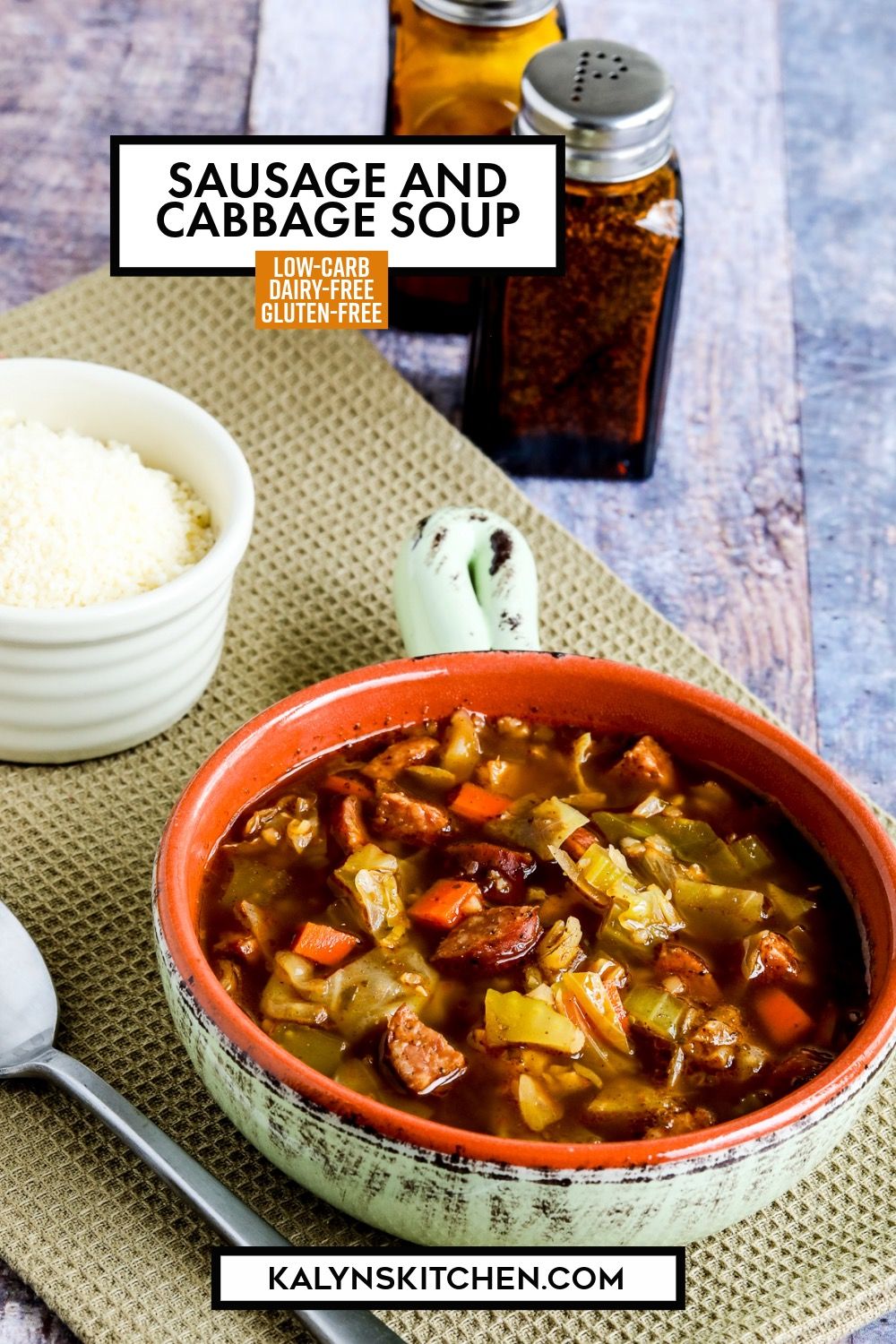 Pinterest image for Sausage and Cabbage Soup showing soup in bowl with spoon and Parmesan.